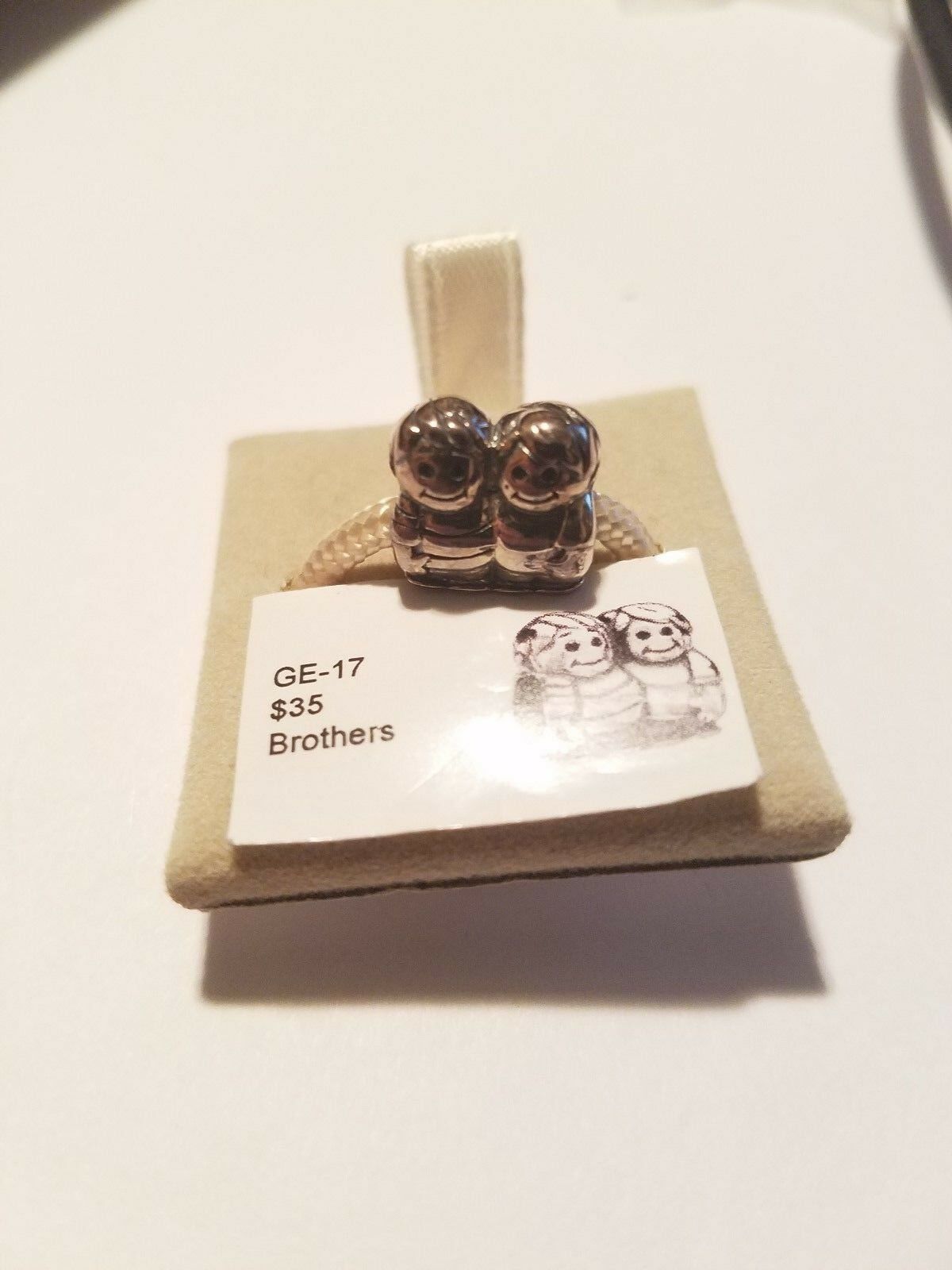 

Authentic Chamilia Brothers Charm