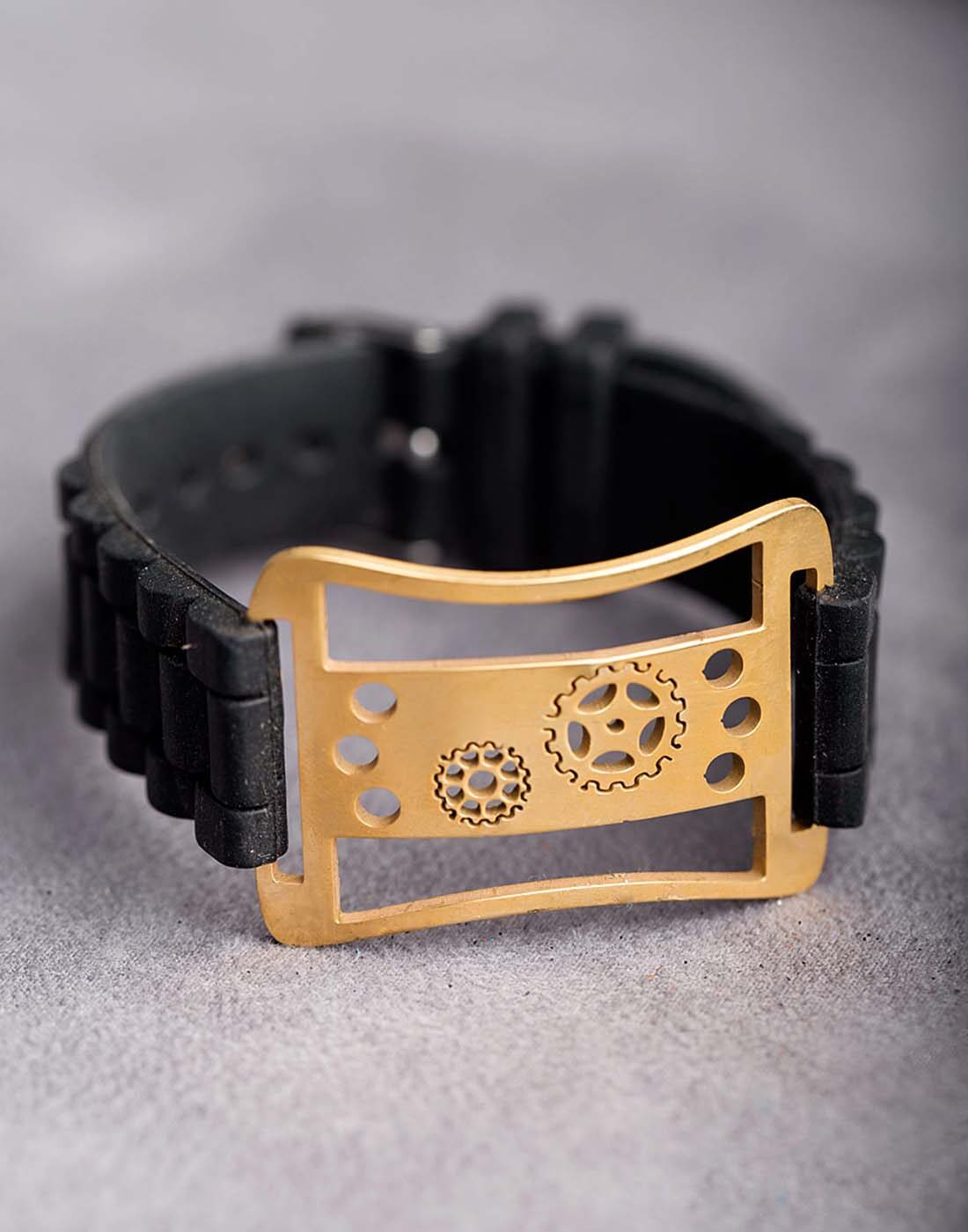 

Dare by Voylla Cut- Out Floral Designer Men s Bracelet With Yellow Gold Tone Black Rubber
