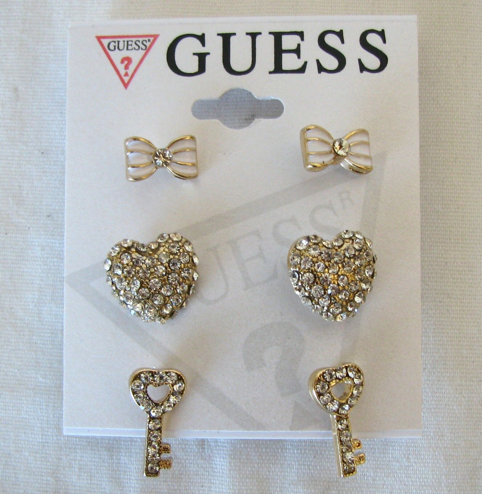

NEW SET OF 3 GUESS GOLD TONE WHITE BOW CRYSTAL HEART KEY STUD EARRINGS