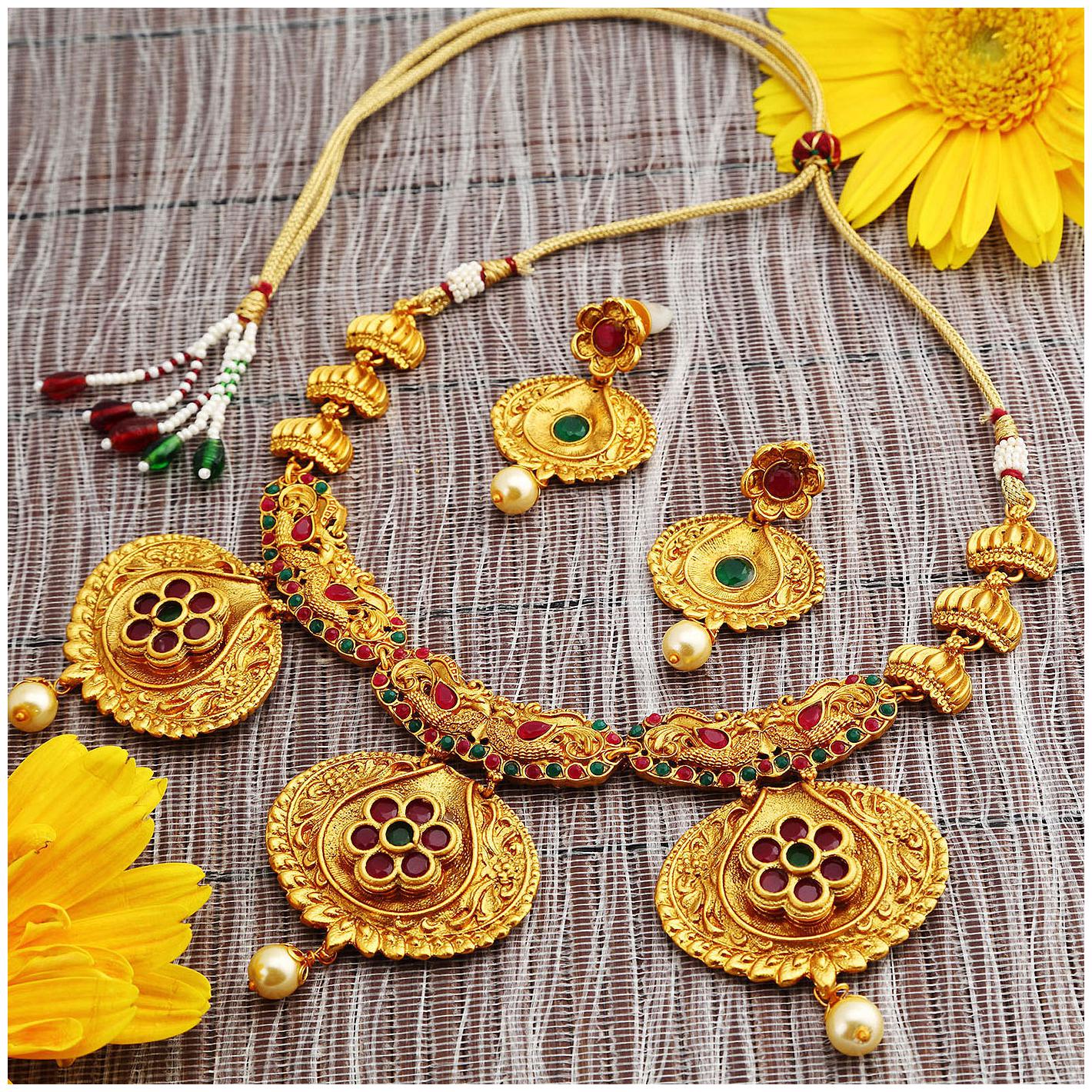 

Sukkhi Estonish Gold Plated Red And Green Stone Necklace Set